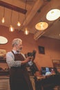 An elderly shoemaker in uniform with a shoe