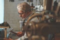 An elderly shoemaker at work