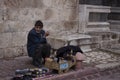 An elderly shoeshiner working on the street in Turkey