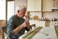 Elderly sick man with glass of water taking pill Royalty Free Stock Photo