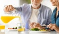 Elderly spouses having breakfast together in kitchen, cropped shot Royalty Free Stock Photo