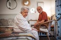 Elderly spouses sharing quiet moment before sleep. Royalty Free Stock Photo