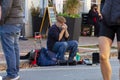 Elderly street musician playing harmonica