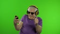 Elderly stylish caucasian grandfather man using social media app on smartphone Royalty Free Stock Photo