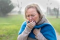 Elderly stylish woman coughing or sneezing Royalty Free Stock Photo