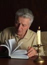 Elderly thoughtful man with book