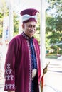 An elderly Turkish musician in a Turkish national costume