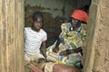 Elderly Ugandan woman cares for grandchild Royalty Free Stock Photo