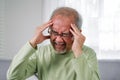 Elderly upset with headache, Senior constipation hand touch head