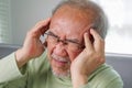 Elderly upset with headache, Senior constipation hand touch head