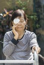 Elderly use eye shield covering after surgery.