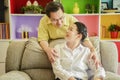 Elderly valentines day, relationships and people concept - happy couple with gift box hugging at home Royalty Free Stock Photo