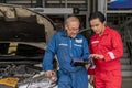 Elderly vehicle mechanic use an obd2 car diagnostics device scanner to interpreting automotive error codes