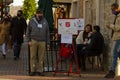 An elderly veteran volunteering as bell ringer for salvation army