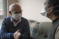 Elderly wearing mask talking about corona-virus Royalty Free Stock Photo