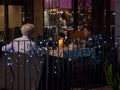 Elderly White Caucasian couple dining al-fresco at Joie vegetarian restaurant, Orchard Central, Orchard Road Singapore