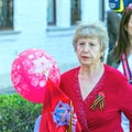 Elderly woman with an air balloon and St. George ribbon