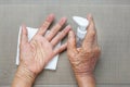 Elderly woman applying hand sanitizer cleaning hands to helping protect from covid-19