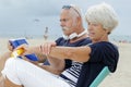 elderly woman applying suncream on beach Royalty Free Stock Photo