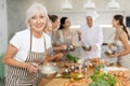 Elderly woman learns to cook at master class