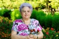 Elderly woman on the background of park vegetation