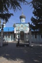 Elderly woman begs for alms at the gates of of the Holy Trinity church in a resort settlement Adler, Sochi