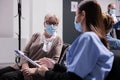 Medium shot of patient at busy clinic, medical consultation Royalty Free Stock Photo