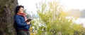 Elderly woman with a book in her hands on the nature. Reading in nature. Rest in the woods. Reading the Bible. Unity with nature Royalty Free Stock Photo