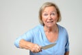 Elderly woman brandishing a kitchen knife Royalty Free Stock Photo