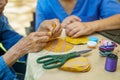 Elderly woman with caregiver in the needle crafts occupational therapy  for Alzheimer or dementia Royalty Free Stock Photo