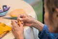 Elderly woman with caregiver in the needle crafts occupational therapy  for Alzheimer or dementia Royalty Free Stock Photo