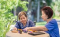 Elderly woman with caregiver in the needle crafts occupational therapy  for Alzheimer or dementia Royalty Free Stock Photo