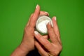 An elderly woman cares for the skin of her hands with a cream Royalty Free Stock Photo