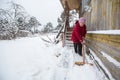 Elderly woman cleans the snow near his home in the village. Help. Royalty Free Stock Photo