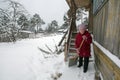 An elderly woman cleans the snow shovel near his home Royalty Free Stock Photo