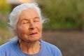The elderly woman with closed eyes Royalty Free Stock Photo