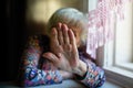 An elderly woman closes face her hand from the camera. Royalty Free Stock Photo