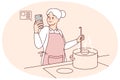 Elderly woman cooking with recipe on cellphone