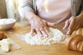 Elderly woman cooks french croissants, bare wrinkled hands, ingredients, soft warm morning light,top view Royalty Free Stock Photo