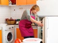 Elderly woman cooks preparing food in the kitchen Royalty Free Stock Photo