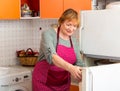 Elderly woman cooks preparing food in the kitchen Royalty Free Stock Photo