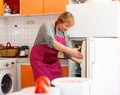 Elderly woman cooks preparing food in the kitchen Royalty Free Stock Photo