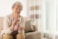 Elderly woman counting coins in living room Royalty Free Stock Photo