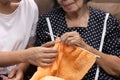 Elderly woman and daughter knitting together for protect dementia and memory loss