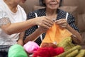 Elderly woman and daughter knitting together for protect dementia and memory loss