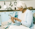 Elderly Woman Using Mobile Phone At Home Royalty Free Stock Photo