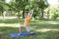 an elderly woman does yoga in the park to perform stretching for balance and balance. Royalty Free Stock Photo