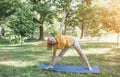 an elderly woman does yoga in the park to perform stretching for balance and balance. Royalty Free Stock Photo