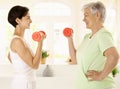 Elderly woman doing dumbbell exercise