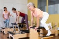 Elderly woman doing exercises on wunda chair in pilates studio Royalty Free Stock Photo